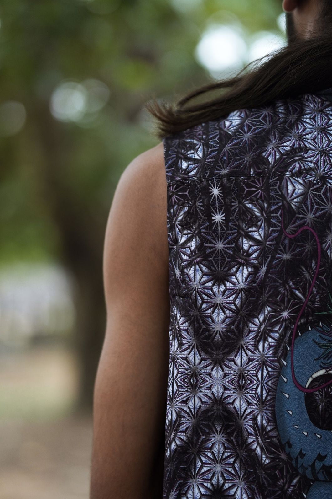 Back view detail of sleeveless bamboo shirt featuring intricate sacred geometry psychedelic pattern