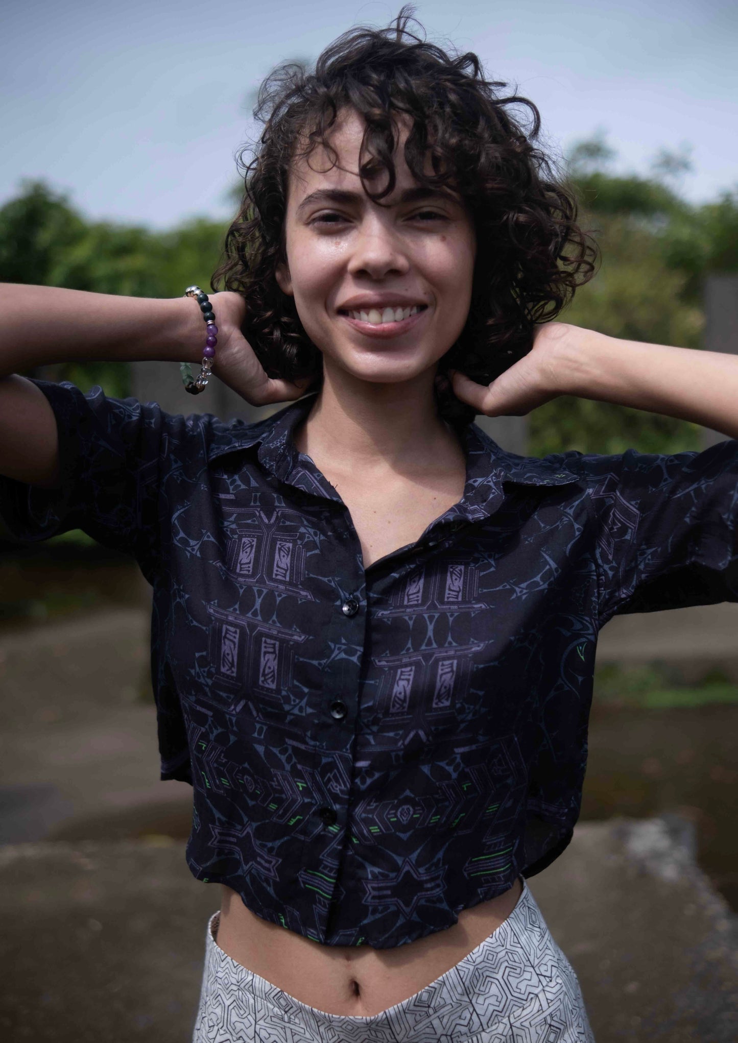 Close-up of Xenomorph bamboo cropped shirt showing abstract purple and orange pattern